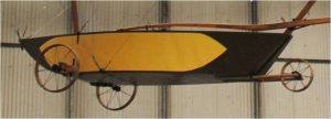 The fuselage under the wing had a seat and a three wheels. The wheel consisted of rims tied to the axle with string to be strong but light. This means George had invented the bicycle wheel.